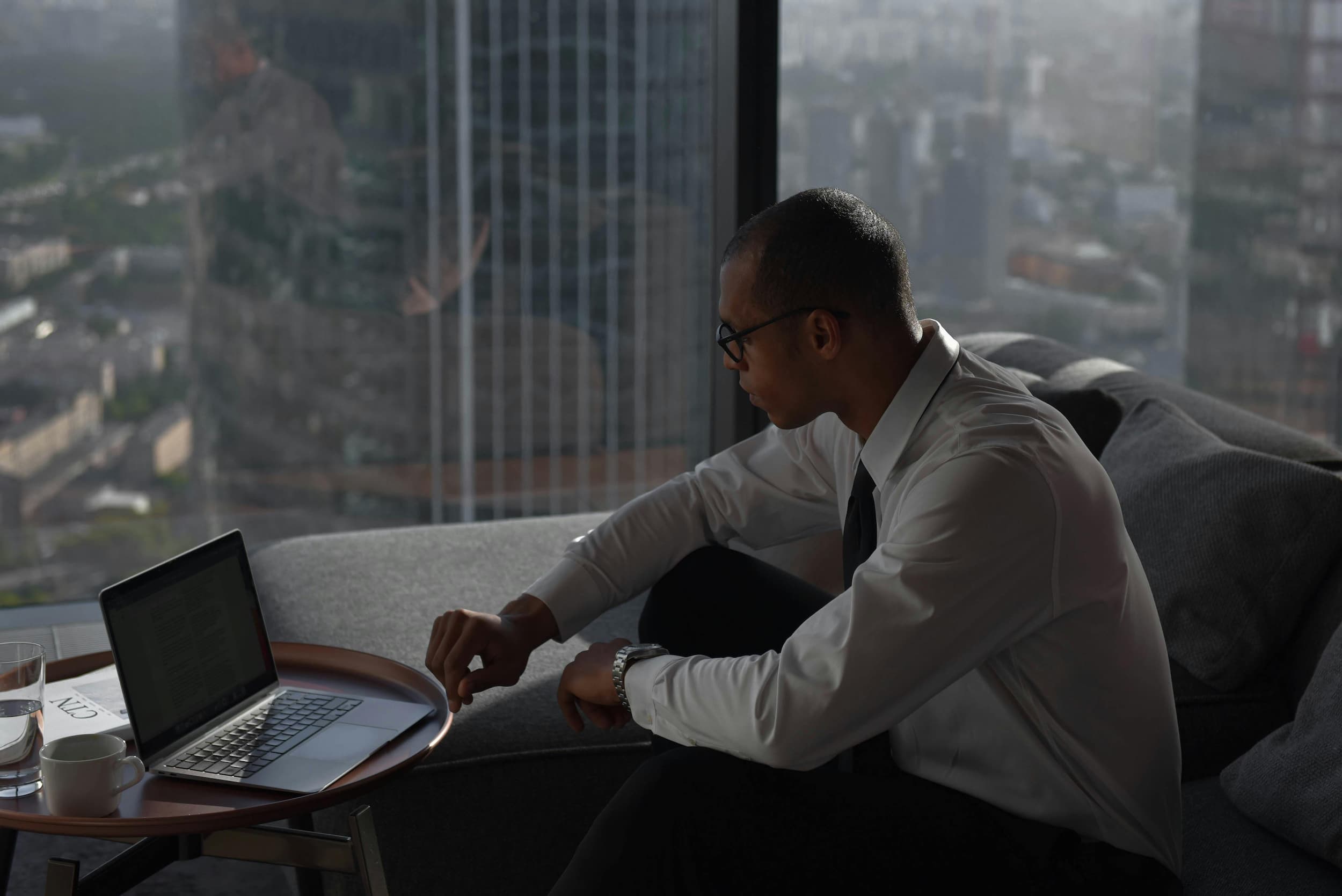 Man using laptop in a high rise building