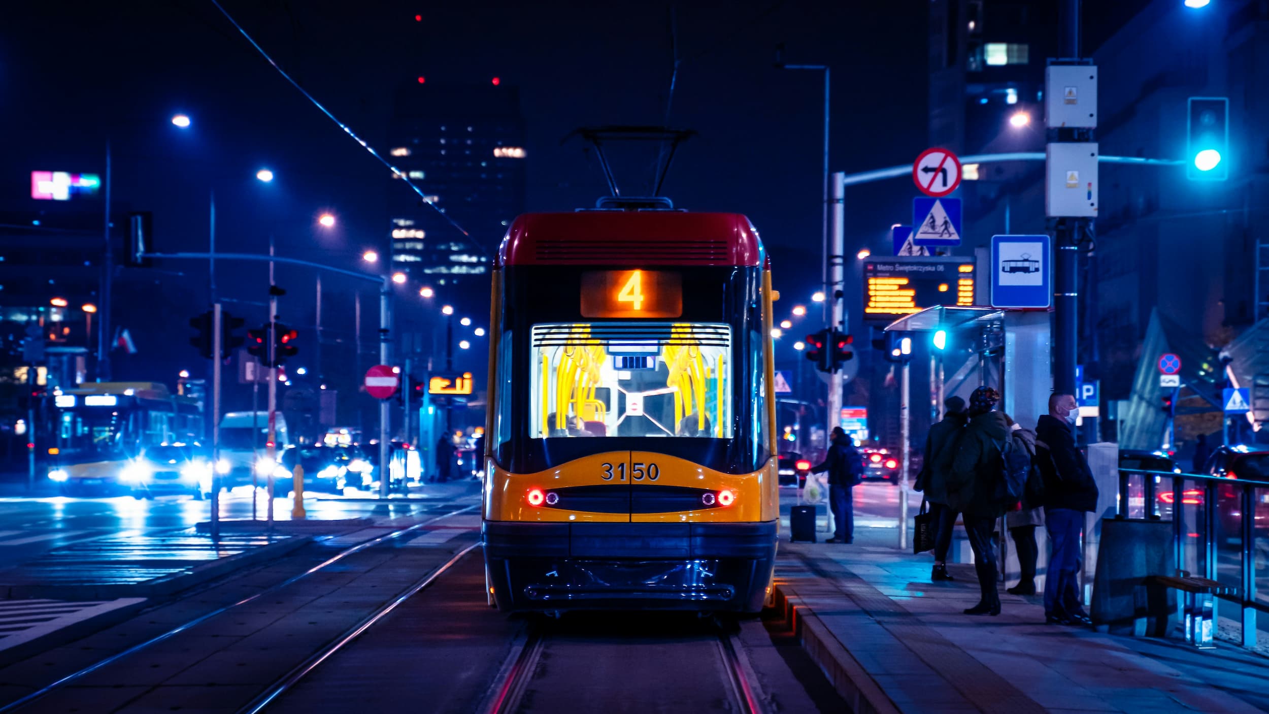 Tram stopped at station picking up passengers at night