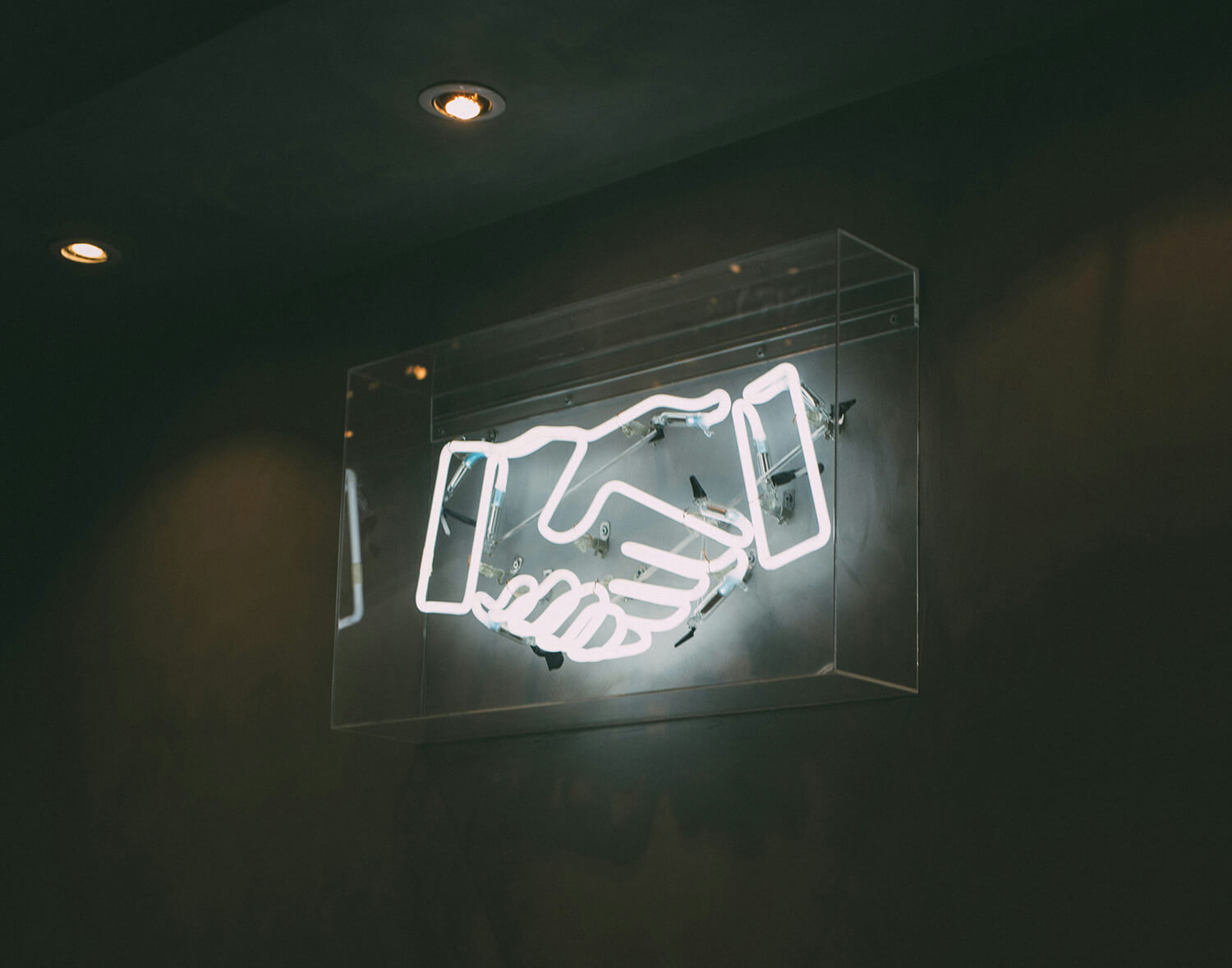 Electric sign of two hands in a handshake